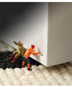 Detail view showing thin polypropylene rug edge with model figures to display thickness