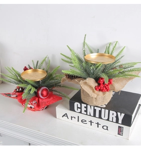 Close-up of a Christmas candle holder with red berries, pine cones and a golden tray