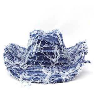 Distressed dark blue denim cowboy hat with vintage frayed edges and white tassel detailing