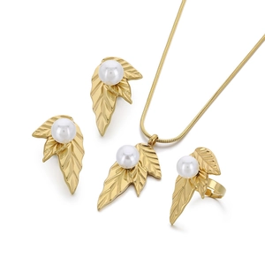 Golden leaf jewelry set with pearls featuring necklace earrings and adjustable ring