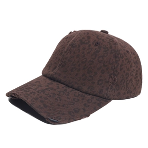 Detail of vintage leopard print baseball cap featuring distressed torn holes and fabric texture