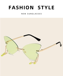 Detail of green butterfly rimless sunglasses with gold metal chain and drop bead