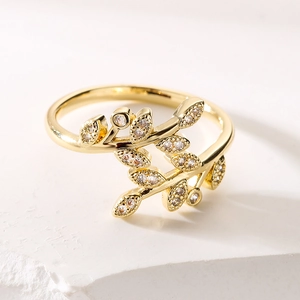 Luxurious gold leaf open ring featuring shimmering zircon stones in a nature design