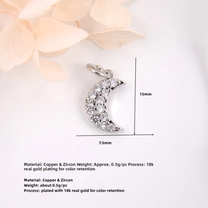 Macro shot of silver crescent moon charm with zircon inlays and precise measurements