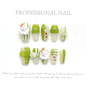 Detail of handmade press-on nails featuring 3D rabbit, white roses, and pearls