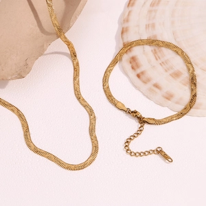 Detailed view of 18K gold-plated stainless steel snake chains with shell and stone accents