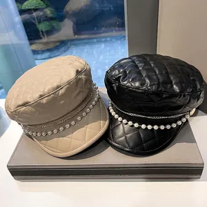 Elegant quilted faux leather baker boy hat with pearl chain trim in beige and black