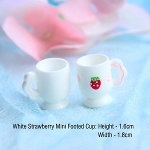 Detailed macro view of two miniature 1.6cm resin goblets with a cute strawberry pattern
