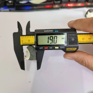 Detailed measurement of a miniature hedgehog figure showing 19.0mm on a digital caliper