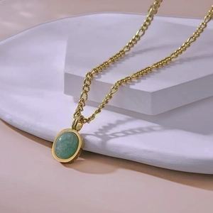 Retro gold chain necklace with oval green amazonite stone pendant on minimal display