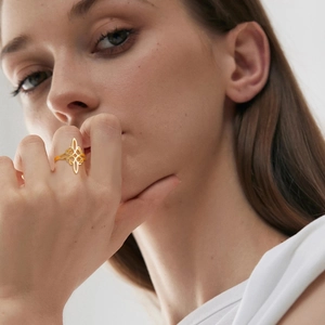 Golden Celtic witch knot hollow ring worn by a model with elegant minimalist style