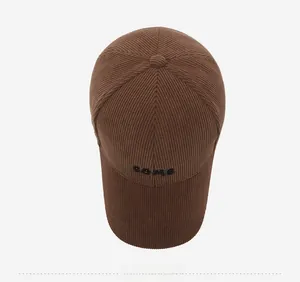 Top view of dark brown corduroy baseball cap featuring detailed SBMC letter embroidery