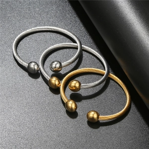 Minimalist twisted cable open cuff bracelet in gold and silver finish with ball ends
