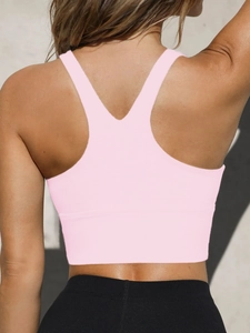 Detail view of pink high-elastic seamless yoga vest with Y-shaped back design and wide hem