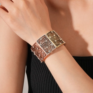 Detailed view of vintage multi-tone hollow bracelet with sparkling white rhinestones