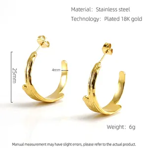 Detail of 18K gold plated stainless steel C-hoop earrings with bark texture and 25mm size
