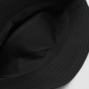 Detailed view of concentric stitching on the brim of a black cotton bucket hat