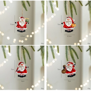 Detail view of four resin Santa Claus pendants with gift boxes and candy canes