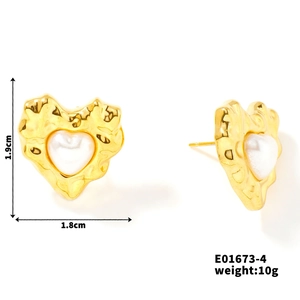 Detailed view of gold textured heart stud earrings with white pearl inlay and size specs