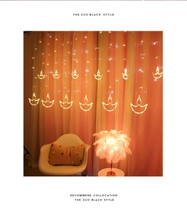 Close-up of warm yellow LED Diya curtain lights for festive Diwali home decoration