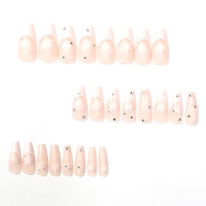 French tip coffin fake nails with white stars and rhinestones on light pink base