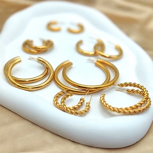 Detailed set of assorted gold-plated hoop earrings with smooth and twisted textures