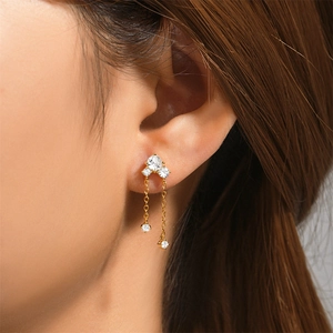 Detail view of gold S925 sterling silver long tassel earrings with sparkling crystals