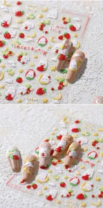 Detailed macro view of 3D embossed nail stickers featuring rabbit and strawberry motifs