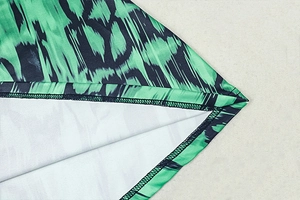 Detail view of the hem stitching and inner fabric of a vintage print pleated A-line dress