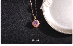 Close-up of rotating sun flower pendant with purple zircon in rose gold titanium steel