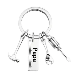 Detailed close-up of stainless steel tools and engraved Papa tag on the silver keychain