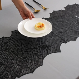Detailed macro view of black lace spider web table runner for Halloween dining decor