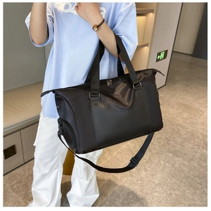 Large black fitness bag side view with dual handles and adjustable shoulder strap
