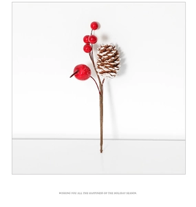 Close-up of red Christmas berries with frosted pine cone branch for holiday decoration
