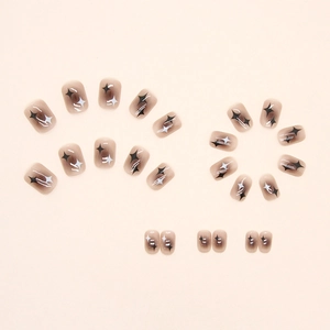 Short square star pattern press-on nails with brown gradient and monochrome star motifs