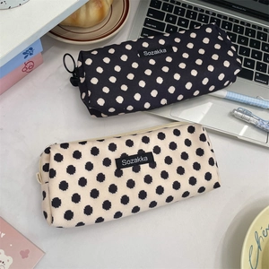 Detailed close-up of retro floral canvas pencil cases with Sozakka brand woven label