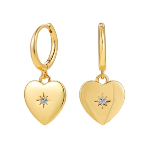 Close-up of 18K gold heart earrings with a starburst diamond on a white background