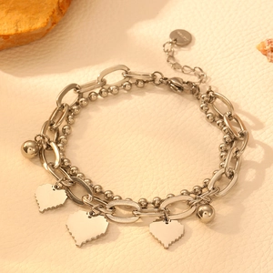 Close-up of silver double-layer bracelet with pixel heart charms and steel beads