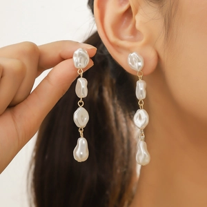 Elegant baroque pearl drop earrings featuring irregular pearls on a gold chain