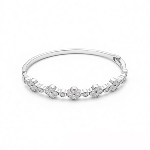 Elegant silver flower bangle with cubic zirconia clover motifs and a polished finish
