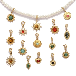 Bohemian pearl necklace with various vintage gold-plated sun and heart pendants