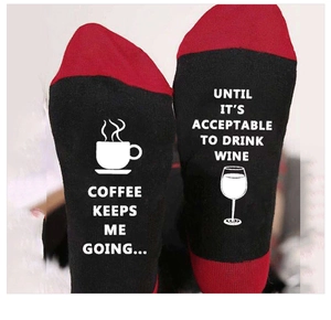 Close-up of funny quote print on the soles of these red and black knitted cotton socks