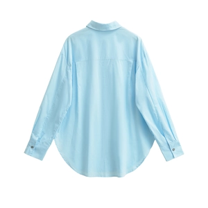 Back detail of light blue long sleeve shirt featuring classic yoke and box pleat