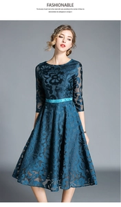 Detail of elegant peacock blue lace embroidery on dress with satin waistband