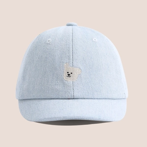 Gros plan détaillé d'une casquette en jean pour bébé avec ours blanc brodé