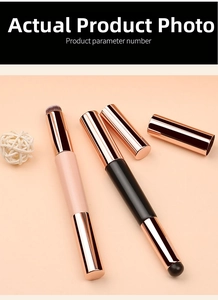 Detailed view of dual-ended silicone lip and concealer brushes with rose gold metal caps