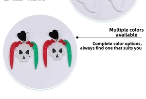 Detailed view of Halloween acrylic skull earrings with glitter accents and red bows