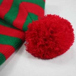 Christmas striped knit beanie with red pom-pom top and vibrant green crochet patterns