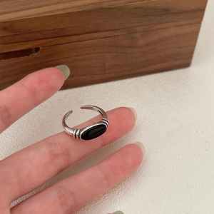 Close-up of 925 sterling silver ring with oval black onyx and adjustable open band