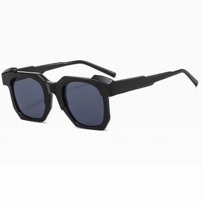 Detail view of bold geometric thick frames and dark lenses on modern fashion sunglasses